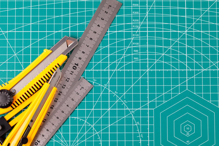 Crafting tools lying on a protective mat for precise cutting and hobby projectsの写真素材