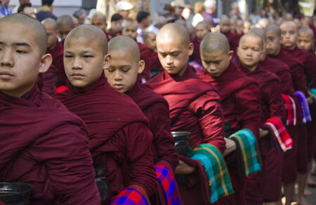 Monks in a row waiting for lunch  Mahagandayon Monasteryのeditorial素材