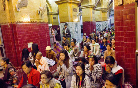 People Praying at the Buddha  A crowd of people praying at the Buddha during an official ceremony in Myanmar  Burma のeditorial素材