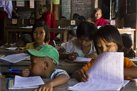Child in a school in Myanmar  A mixed class with children of different ages,  studying different matters  のeditorial素材