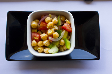 Garbanzo Bean Salad. A fresh chickpea salad for the summer season, done with raw vegetables such as onion, green pepper, celery, tomato and parsley. An healthy an easy recipe!の写真素材