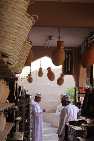 A typical souvenir shop in Nizwa City, Oman, near the famous Castle  Many vases in terracotta of different sizes and colours, postcards, cup, mug, etc  I lovet the archs and the hung amphorasのeditorial素材