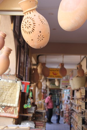 A typical souvenir shop in Nizwa City, Oman, near the famous Castle  Many vases in terracotta of different sizes and colours, postcards, cup, mug, etc  I lovet the archs and the hung amphorasのeditorial素材