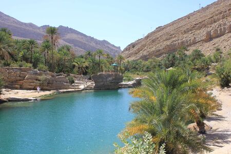 Moqul Cave in Wadi Bani Khalid, an oasis in the Oman desert landscape の写真素材