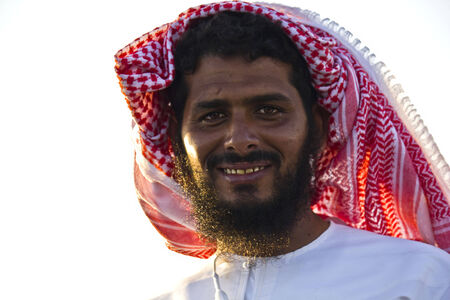 Moqul, Oman, October 22, 2013: Omani man with beard and the typical dress. He is wearing the typical hat Mussar (turban). He was smiling at me.のeditorial素材