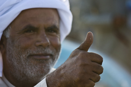 Moqul, Oman, October 22, 2013: Omani man with typical dress. He is wearing the typical hat Mussar (turban)のeditorial素材