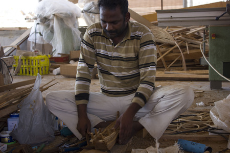 Sur, Oman, October 23, 2013: Man at work building a boat. Boat in Oman are built manually using woodのeditorial素材