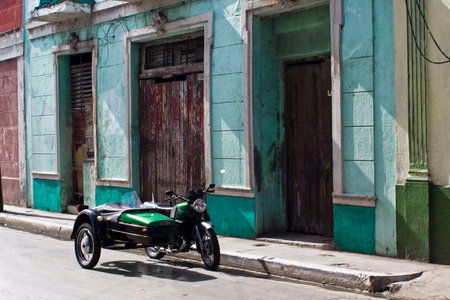 Green vintage sidecar in a cuban street. In Matanzas, west side from Havana in Cuba, an old...