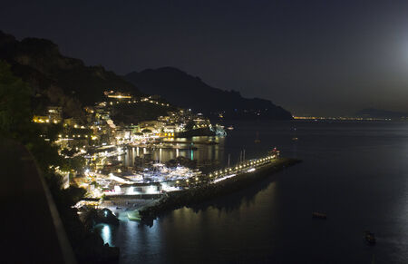 Amalfi, Italy, August 11, 2014: Amalfi Coast by night. The Amalfi Coast (Italian: Costiera Amalfitana) is a stretch of coastline on the southern coast of the Sorrentine Peninsula in the Province of Salerno in Southern Italyのeditorial素材