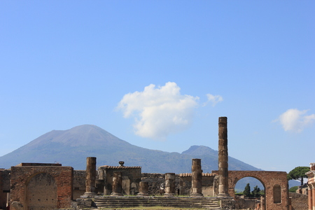 Pompei, Italy: View of the The Temple of Jupiter with Vesuvius volcano in the distance, from the forum of the famous ancient city of Pompei, Italy.の写真素材