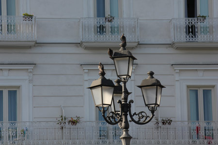 Amalfi, Italy: Architectural detail of a street lamp, with pigeons on itの写真素材