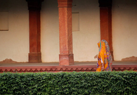 Agra, India: Fatehpur Sikri, a city and a municipal board in Agra district, India. A walled city, one of of the best preserved collections of Indian Mughal architecture in India. Indian woman walking in itのeditorial素材