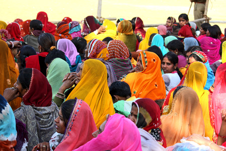 Pushkar, India: Crowd of people at Pushkar fair, in the Indian Rajasthan state, waiting for an exhibition. Many beautiful woman colorful saree.のeditorial素材