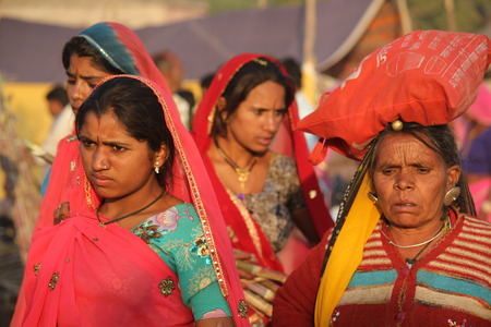 PUSHKAR, INDIA : Indian girls with traditional colored saree on the street of Pushkar during the Camel Fair exhibitionのeditorial素材