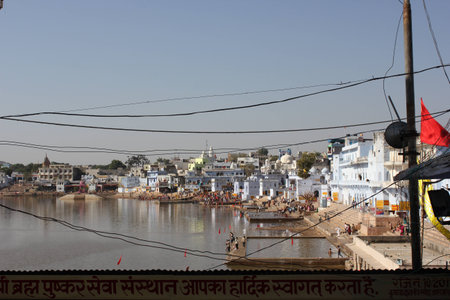 PUSHKAR, INDIA: View of Pushkar Lake through buildings. It  is a sacred lake of the Hindus