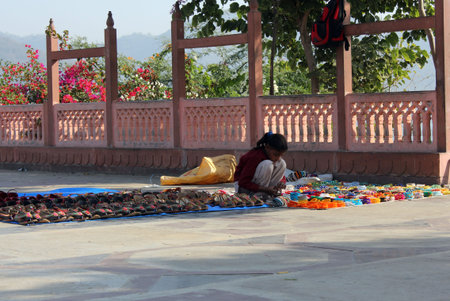 JAIPUR, INDIA : Young Indian girl selling shoes and bangles in the street of Jaipurのeditorial素材