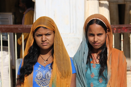 Jaipur, India: Two Indian girls, with traditional sari, looking at the cameraのeditorial素材