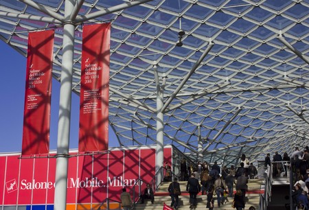 MILAN, ITALY - APR 9: Entrance of the Milan Trade fair during the Salone del Mobile on April 9 2014, with its modern architectural roof made of glass and steel with people walking aroundのeditorial素材