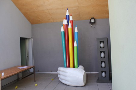 MILAN, ITALY - APRIL 11: Sculpure of a hand holding colored pencils on display during the Milan Design week in Ventura district, on April 11 2014のeditorial素材