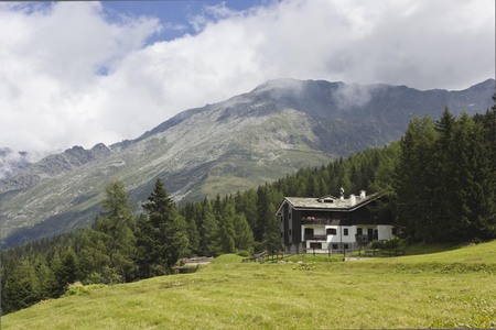 MADESIMO, ITALY - AUG 18 2014: Mountain landscape overview in the summer in Madesimo, with a chalet のeditorial素材