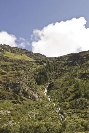 MADESIMO, ITALY - AUG 21: Madesimo Valley floor, natural and peacuful landscape in the summer season with a torrent crossing in the middleのeditorial素材