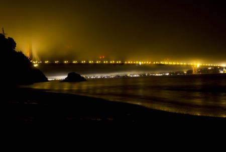 SAN FRANCISCO, USA - AUG 11 2013: Foggy Night in San Francisco, view of Golden Gate bridge lights from Kirby Cove campground beachのeditorial素材