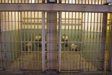 ALCATRAZ, USA - AUGUST 12 2013: Close up of an Alcatraz Cell, with its sbars and the poor furnitureのeditorial素材