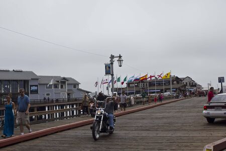 SANTA BARBARA, USA - AUG 15 2014: Grey day in Santa Barbara, California. Image taken from the pier with a moto and people walkingのeditorial素材