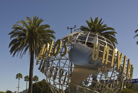 LOS ANGELES, CALIFORNIA - AUG 17 2013: Universal Studios Hollywood sign at the entrance of the amusement Park, suroounded by palmsのeditorial素材