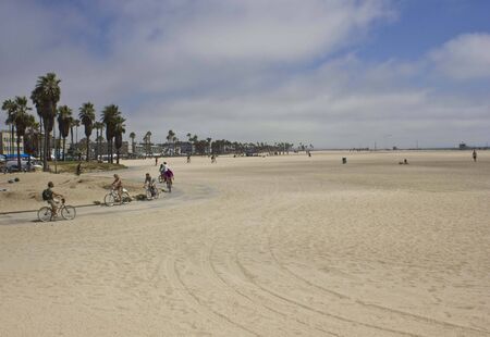 VENICE BEACH, USA - AUG 17 2013: People cycling on the cycling lane of Venice Beach in Californiaのeditorial素材