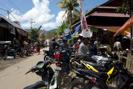 TANA TORAJA, INDONESIA - JULY 4 2012: People along the street of a little rural village in Tana...
