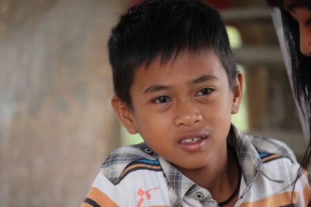 SULAWESI, INDONESIA - JULY 2 2012: Portrait of a young Indonesian boy in the streetのeditorial素材