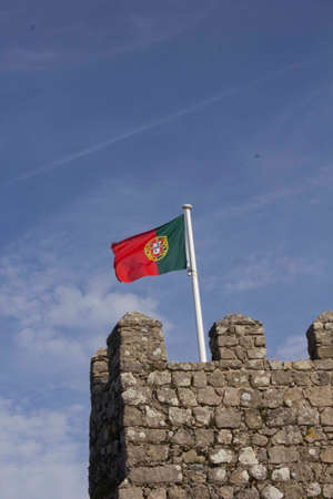 SINTRA, PORTUGAL - OCTOBER 25 2014: Portuguese flag waving from the old tower of Castle of the Moors in Sintra, Portugalのeditorial素材