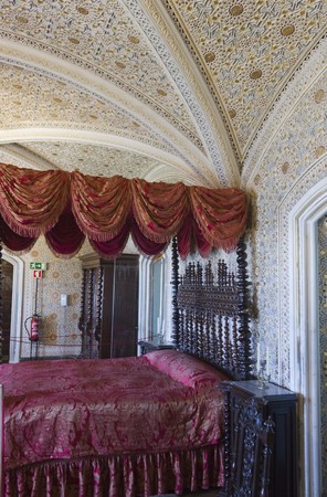 SINTRA, PORTUGAL - OCTOBER 25 2014: Bedroom in Sintra National palace, with traditional red canopy bedのeditorial素材