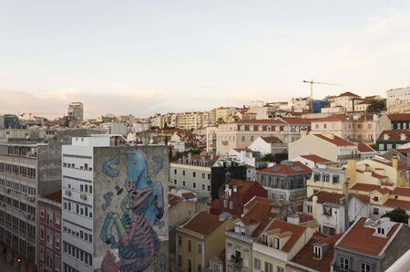 LISBON, PORTUGAL - OCTOBER 23 2014: View from the top of downtown Lisbon at sunset time, with a big seahorse mural on a building facadeのeditorial素材