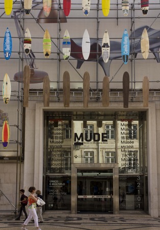 LISBON, PORTUGAL - OCTOBER 24 2014: The facade of Muse Museum of Fashion and design in Rua Augusta in Lisbon, with surfboards on the facade and person walking on the street.のeditorial素材