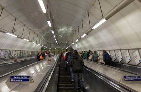 LONDON, UNITED KINGDOM - SEPTEMBER 12 2015: People on underground tunnel staircase in London.