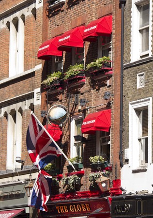LONDON, UNITED KINGDOM - SEPTEMBER 12 2015: The Globe pub and kitchen in London, with its red curtains on the facadeのeditorial素材