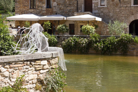 BAGNO VIGNONI, ITALY - JUNE 3 2017: Metal Wires transparent sculpture by Italian sculptress Daniela Capaccioli in Bagno Vignoni medieval town in Tuscany, Italyのeditorial素材