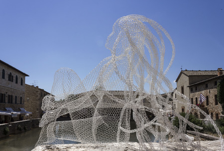 BAGNO VIGNONI, ITALY - JUNE 3 2017: Metal Wires transparent sculpture by Italian sculptress Daniela Capaccioli in Bagno Vignoni medieval town in Tuscany, Italyのeditorial素材