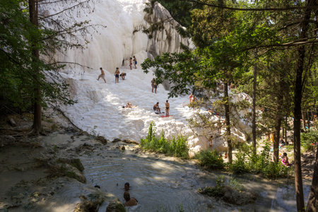 Bagni San Filippo, Italy - June 2 2017: People bathing in Bagni San Filippo natural thermal pools in Tuscany, Italyのeditorial素材