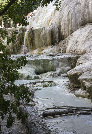 BAGNI SAN FILIPPO, ITALY - JUNE 2 2017: Mineral rock of Bagni San Filippo in Italy, with its hot spring stream, surrounded by natureのeditorial素材