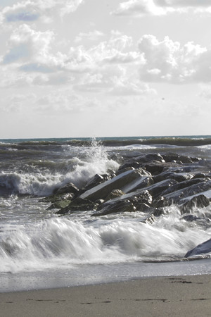 MARINA DI MASSA, ITALY - AUGUST 17 2015: Waves crashing into rocks in Marina di Massa, Italyのeditorial素材