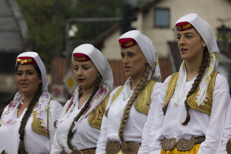 SARAJEVO, BOSNIA AND HERZEGOVINA - AUGUST 20 2017: Group of traditional dressed bosnian girls in front of Sebilj fountain, holding tambourinesのeditorial素材