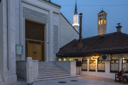 SARAJEVO,BOSNIA AND HERZEGOVINA - AUGUST 19 2017: View at sunset of the building of the Gazi Husrev begova library in Sarajevo, with clock tower and minaret in the backgroundのeditorial素材