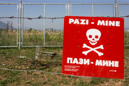 SARAJEVO, BOSNIA AND HERZEGOVINA - AUGUST 19 2017: Caution mines sign in a minefield in Sarajevo