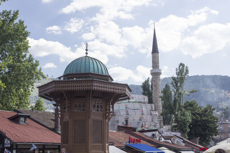 SARAJEVO, BOSNIA AND HERZEGOVINA - AUGUST 2017: Architecturak slose up of the rooftop of Sebilj fountain and modque minaret under renovation work, Sarajevoのeditorial素材