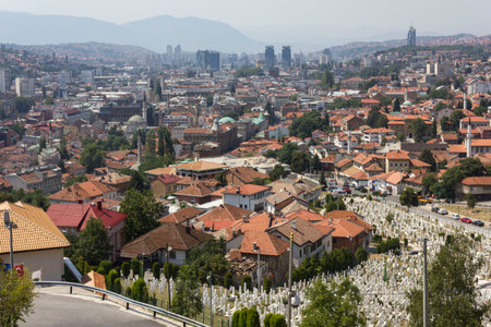 SARAJEVO, BOSNIA AND HERZEGOVINA - AUGUST 19 2017: View from the top of Yellow Fortess of the city of Sarajevo, with a huje war cemetery in the foregroundのeditorial素材