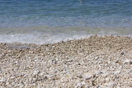 TUCEPI, CROATIA - Stobrec beach with its white pebbles and crystalline beachの写真素材