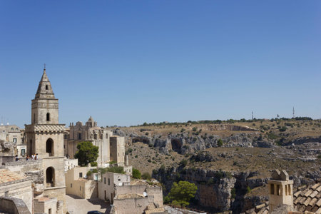 MATERA, ITALY - AUGUST 25 2017: Ancient bell tower facing Matera landscape,Italy